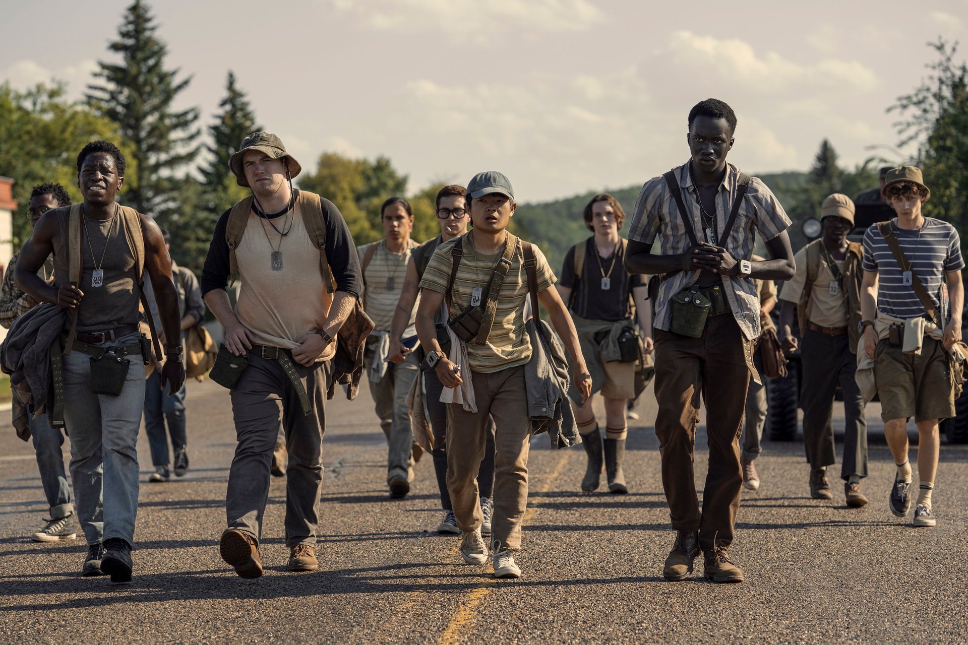 David Jonsson as McVries, Cooper Hoffman as Garraty, Jordan Gonzalez as Harkness, Ben Wang as Olson, and Tut Nyuot as Baker in The Long Walk. Photo Credit: Murray Close/Lionsgate